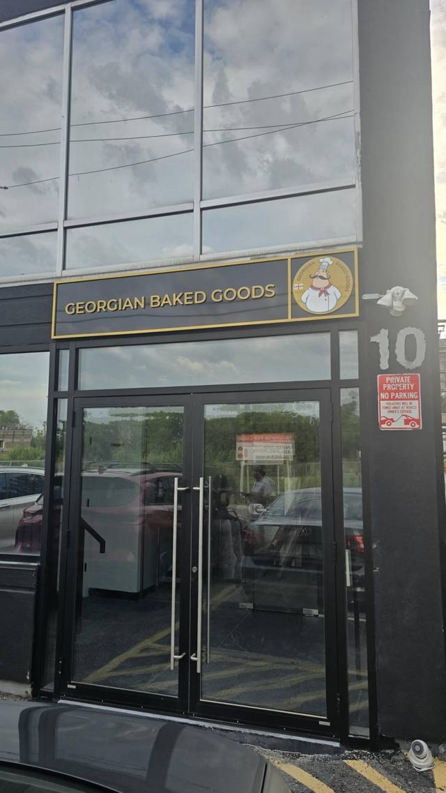 The Georgian Baked Goods storefront at 10 Plastics Avenue, with a black and gold sign above glass doors